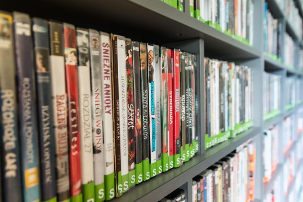 DVD cases lined up on library shelves